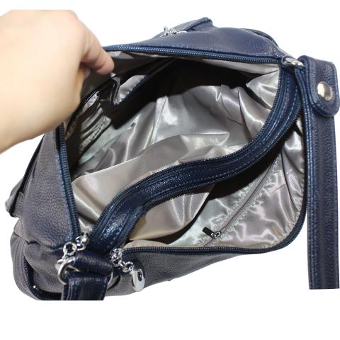 Look material is adorned with silver hardware and two zipped pockets on front, top zipped pocket, an exterior pocket on back and an adjustable cross body strap.